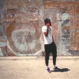 Nipsey Hussle standing proud, symbolizing his influence in hip-hop and the community