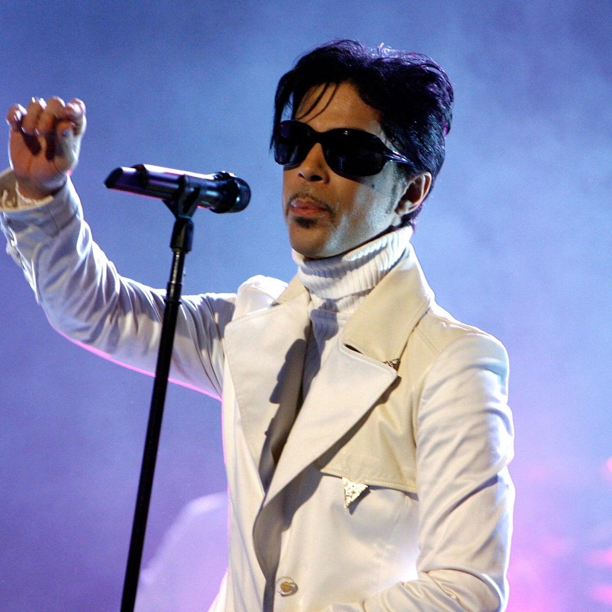 Prince in all white performing